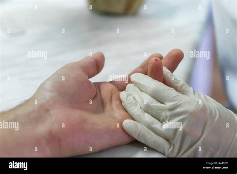 Finger blood test in the laboratory. The doctor pierces a finger. Close-up Stock Photo - Alamy