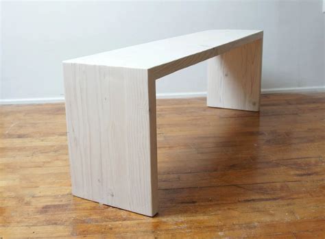 a wooden bench sitting on top of a hard wood floor