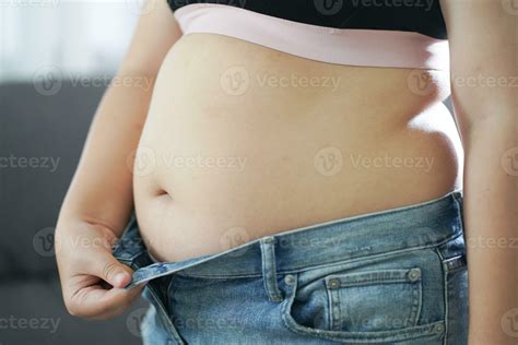 Obese Woman with fat upset about her belly. Overweight woman touching