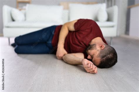 unconscious young man lying  floor stock photo adobe stock