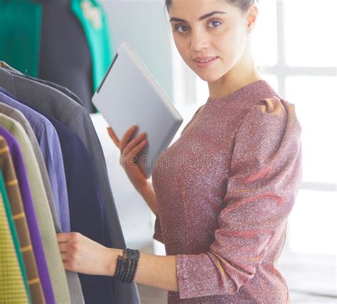 beautiful young stylist  rack  hangers stock photo image