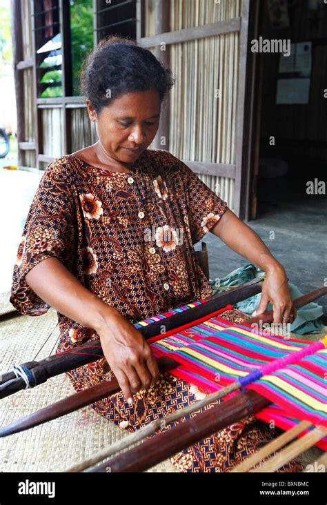 Woman traditionally weaving tais on backstrap loom in Timor Leste (East ...