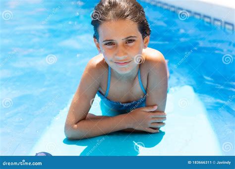 Cute Girl Playing with a Bodyboard in a Swimming Pool. Stock Image ...