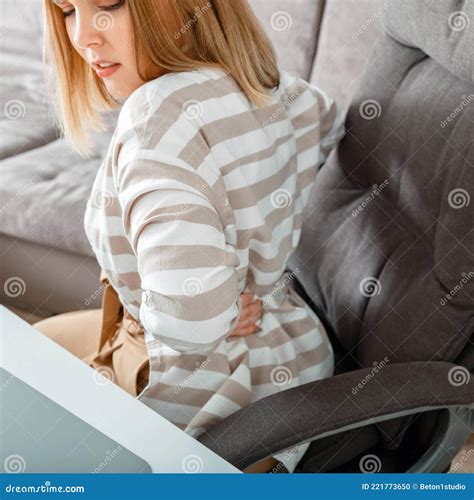 Young Woman Have Back Pain Sitting on Office Chair at Home. Acute Neck
