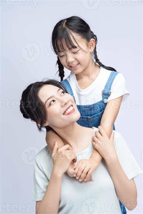 Image of Asian mother and daughter on background 20508396 Stock Photo