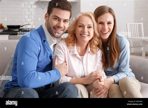 young family  mother  law  home weekend hugging smiling stock