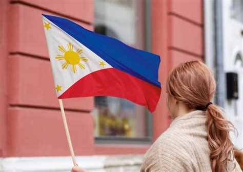 Premium Photo | Medium shot woman holding philippine flag