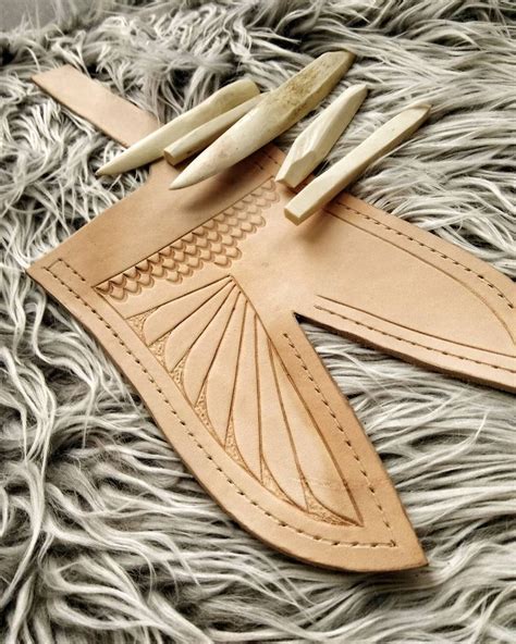 Leatherwork today, making a Ventulus sheath with some feathers. I used ...