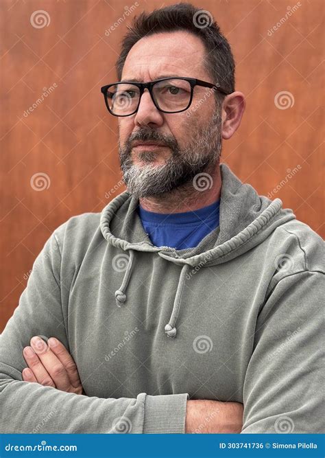 Portrait of Pensive and Worried Adult Man with Beard and Glasses
