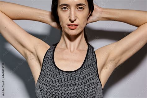 A woman raised her hand to show the hair under her armpits. A natural ...
