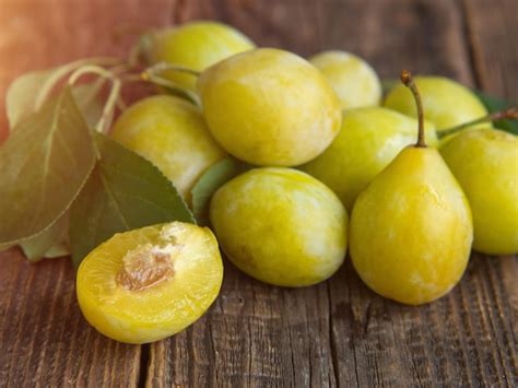 Premium Photo | Fresh yellow plum closeup yellow plum in on a wooden ...