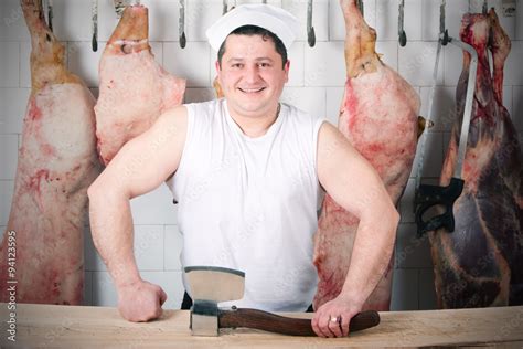 Powerful butcher showcasing his strength and expertise,wielding a ...