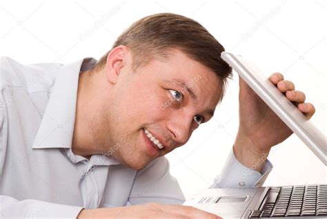 Young man looks at a laptop on a white background — Stock Photo ...