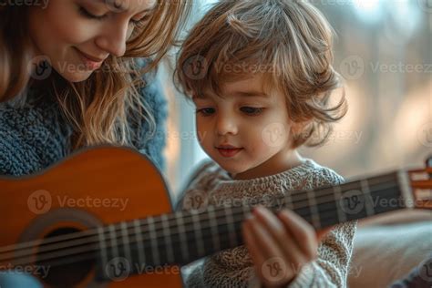 A mother teaches her young son to play guitar on a cozy afternoon at