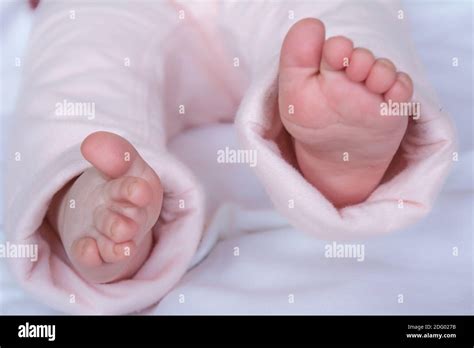 little baby feet in white pants Stock Photo - Alamy