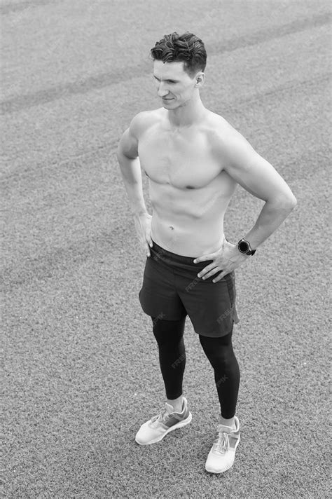 Premium Photo | Confident young fitness man with strong hands strong