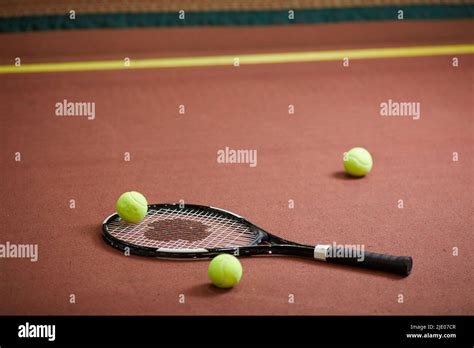 Close-up of modern tennis equipment scattered on floor of indoor tennis ...