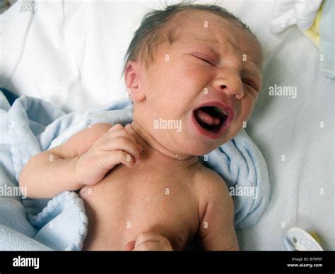 One week old baby boy crying on hospital bed Stock Photo - Alamy