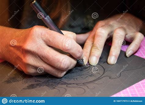 Close Up Of Artists Hands While Making A Custom Designed Paper Cutting ...