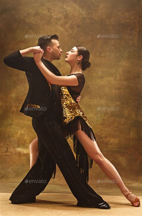 Dance ballroom couple in gold dress dancing on studio background ...