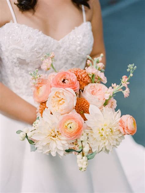 bridal bouquet featuring peach  white flowers   serene outdoor