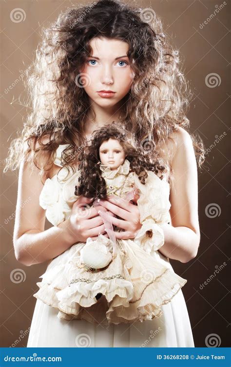 Young woman with doll stock photo. Image of background - 36268208
