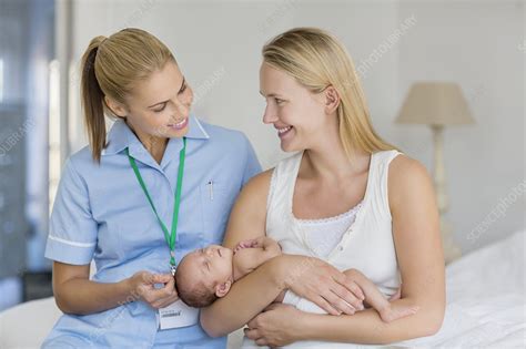 Mother and nurse with newborn baby - Stock Image - F013/7240 - Science Photo Library