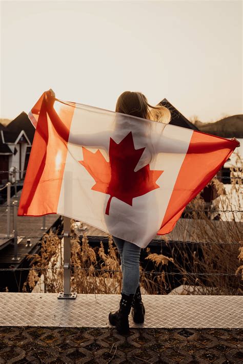 Download Proud Canadian Woman holding National Flag Wallpaper