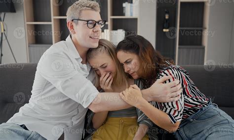 Caucasian father and mother hugging comforting depressed teenage