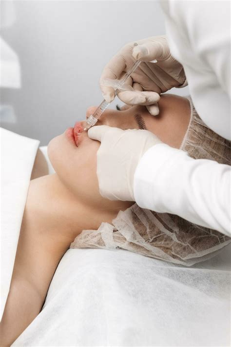 close-up, female lips. Surgeon, in medical gloves, carefully and slowly
