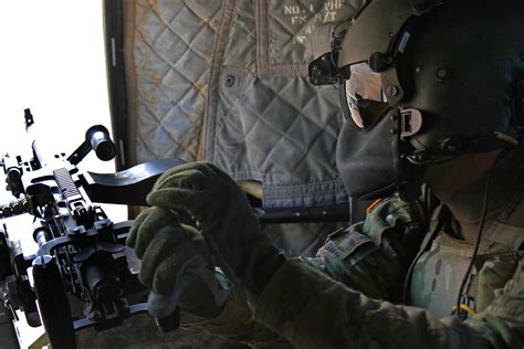 An Army door gunner prepares to conduct a test fire with a M240 machine