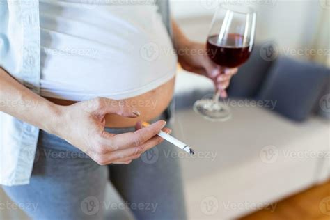 Smoking and alcohol pregnancy.woman on a long pregnancy drinking