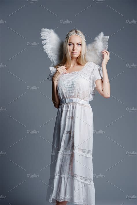 Beautiful blonde girl portrait containing angel, wings, and adult