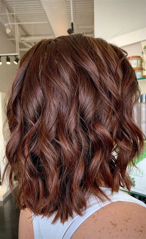 Enchanting Hair Colour Trends to Illuminate 2024 : A Spun Dark Auburn Bob