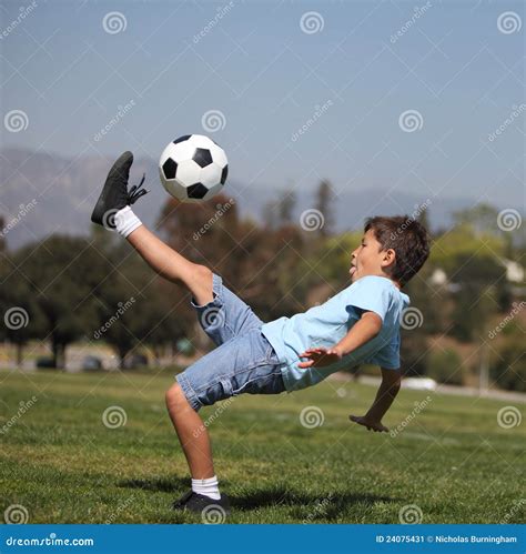 Boy Kicking Soccer Ball Stock Image - Image: 24075431