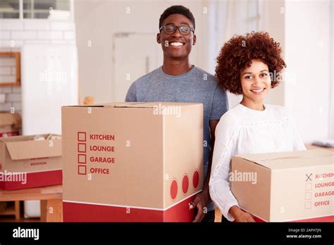 portrait couple carrying boxes  res stock photography  images alamy
