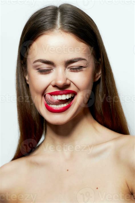 Attractive woman naked shoulders closed eyes red lips tongue touch spa