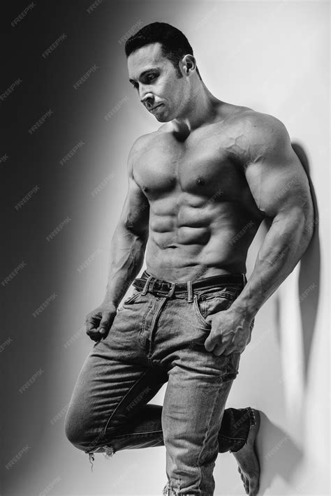 Premium Photo | A young athlete bodybuilder poses in the studio topless