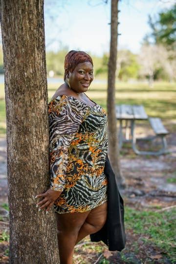 Big Black Beautiful BBW Model Posing Outdors in an Animal Print Dress