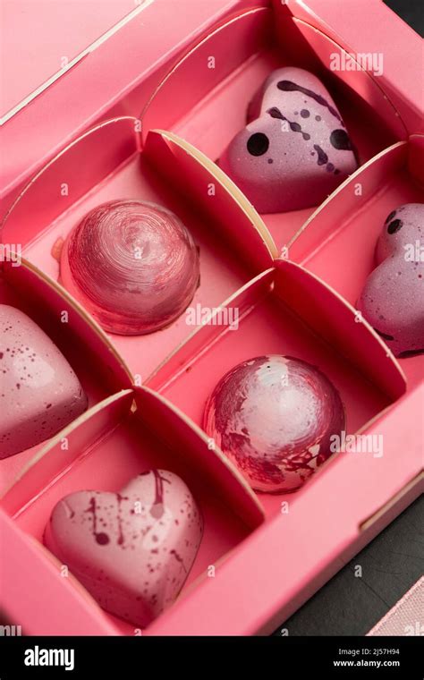 luxury handmade pink chocolate candy  pink box isolated  dark