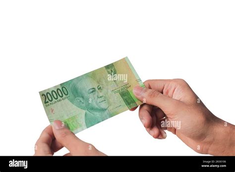mans hand showing twenty thousand rupiah isolated  white background