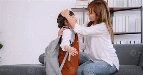 Lovely daughter embraced her mother before going to school on the first