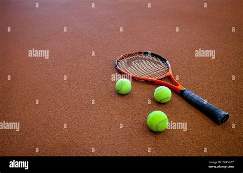 A hard tennis court and a tennis raquet,with three balls Stock Photo ...