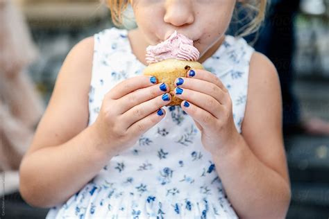 "Little Girl Eats A Cupcake At A Party" by Stocksy Contributor "Cara ...