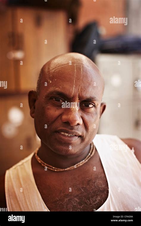 Smiling man wearing gold necklaces stock photo