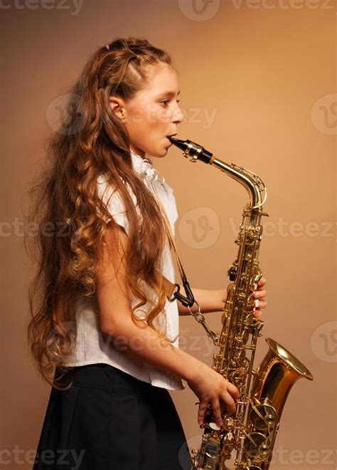 Half-face view of girl playing alto saxophone 1422858 Stock Photo at ...