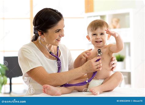 woman pediatrician examining  baby kid  stethoscope stock photo