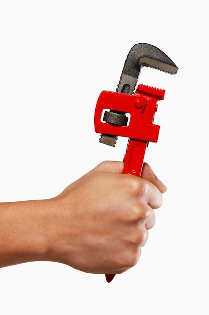 premium photo cropped hand holding spanner  white background