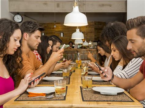 family dinner table cell phones stock   royalty