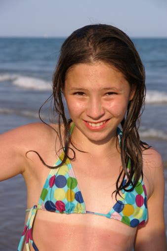 Girl With Sunburn Blinks Against The Sun Stock Photo - Download Image